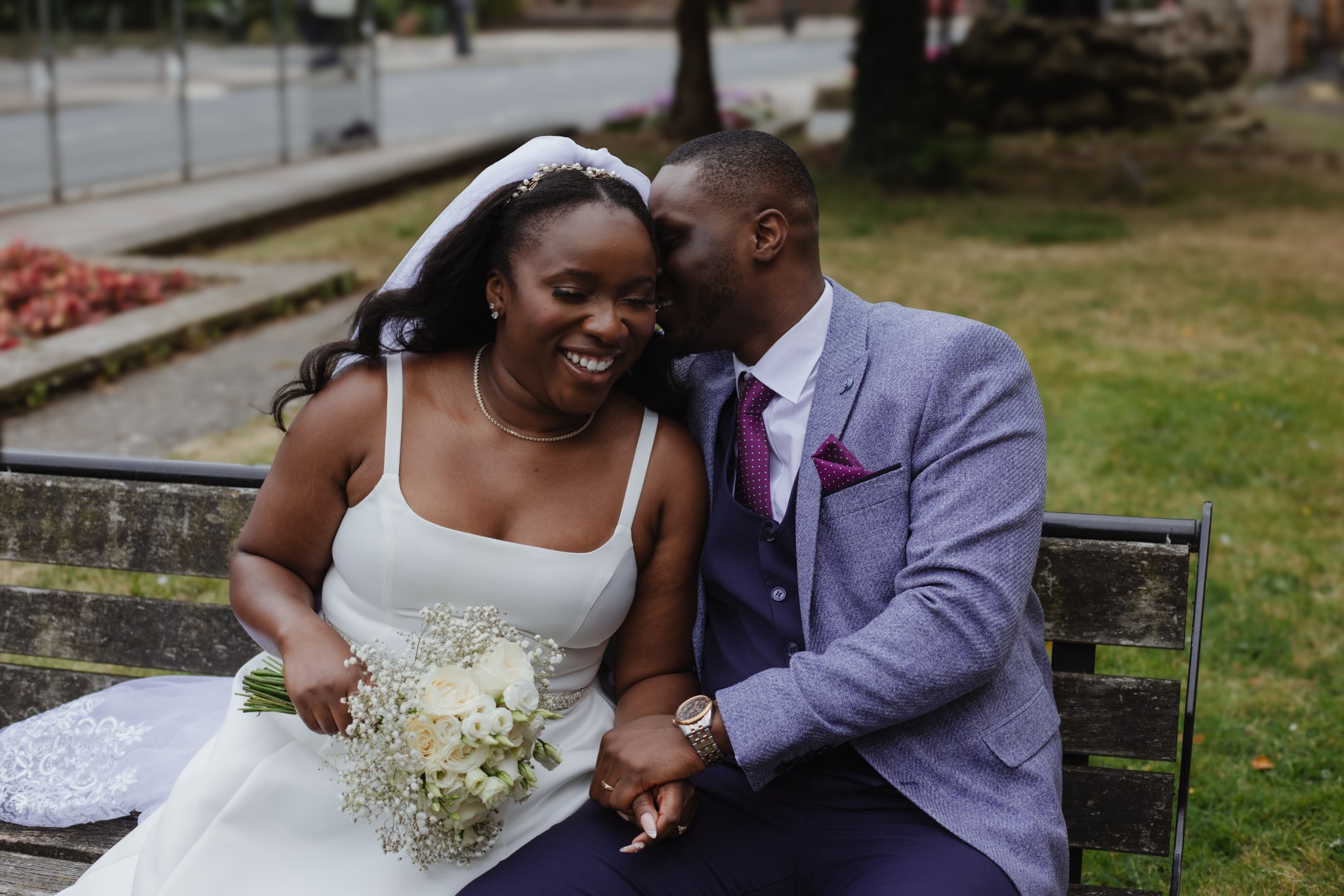 Bride and groom laughing together during an outdoor wedding portrait session.
