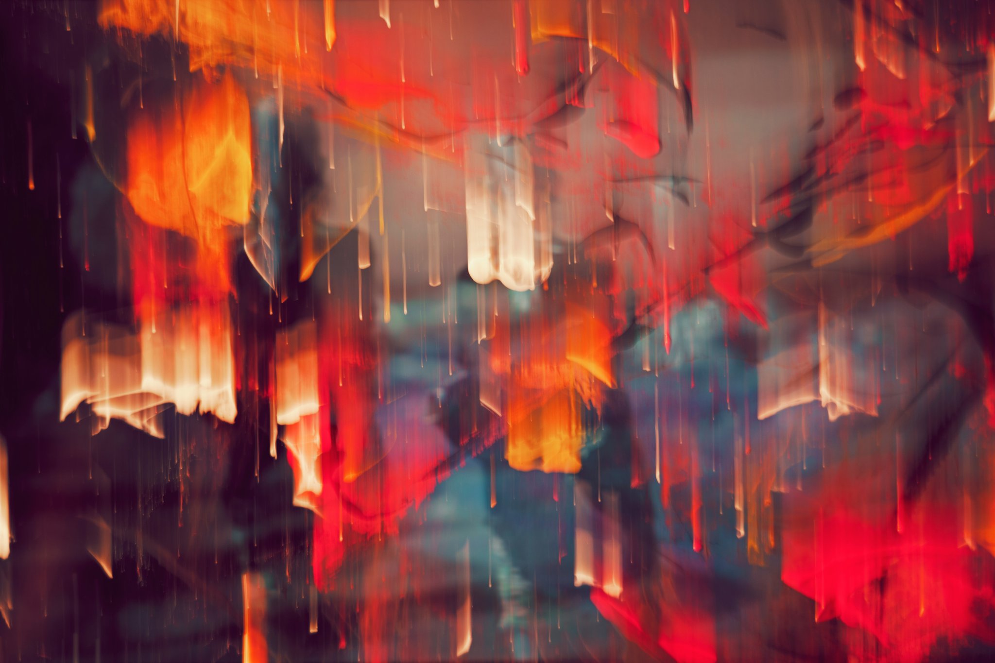 Abstract photograph with blurred streaks of red, orange and blue light.