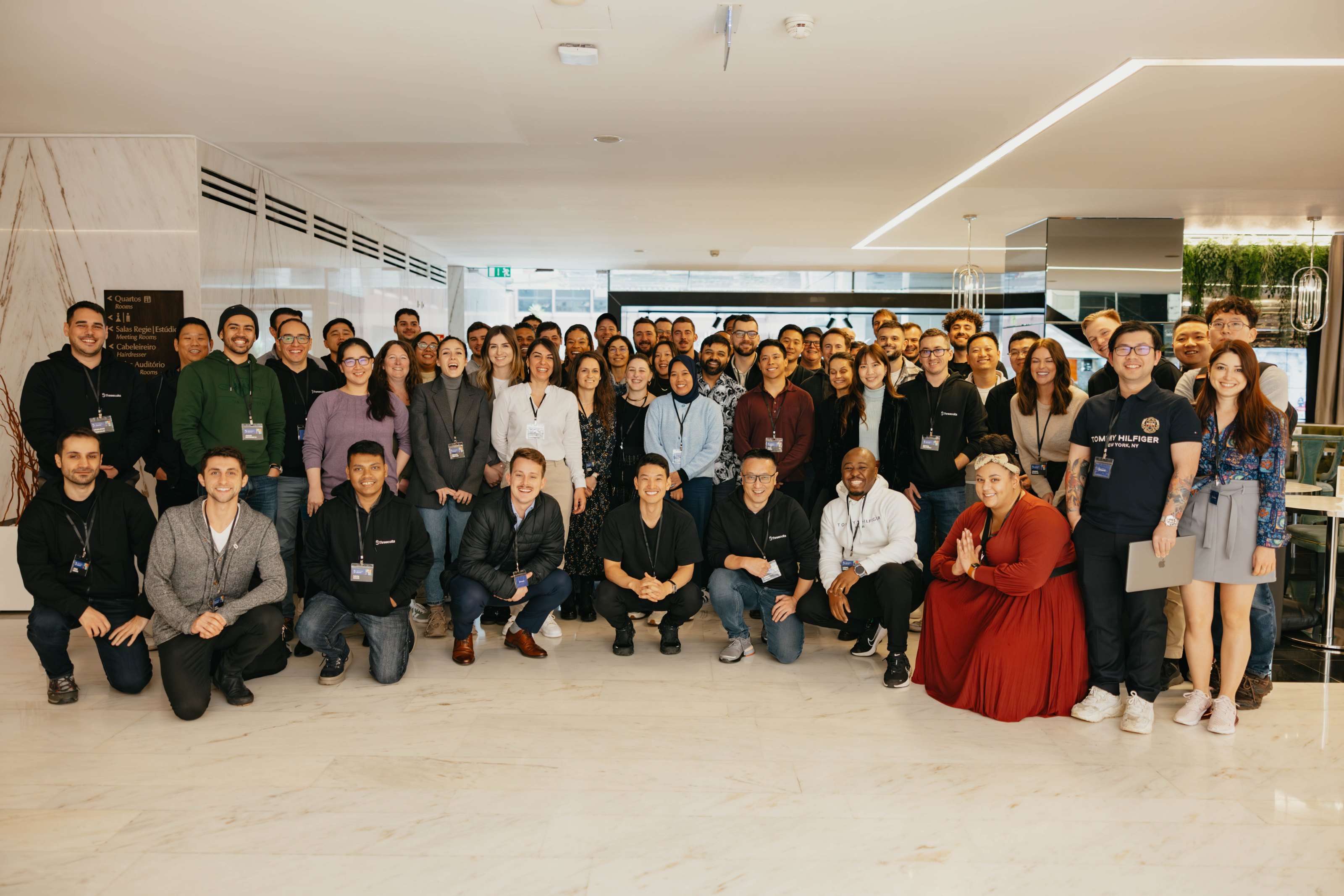 Large group of colleagues posing together for a photograph at a company event.