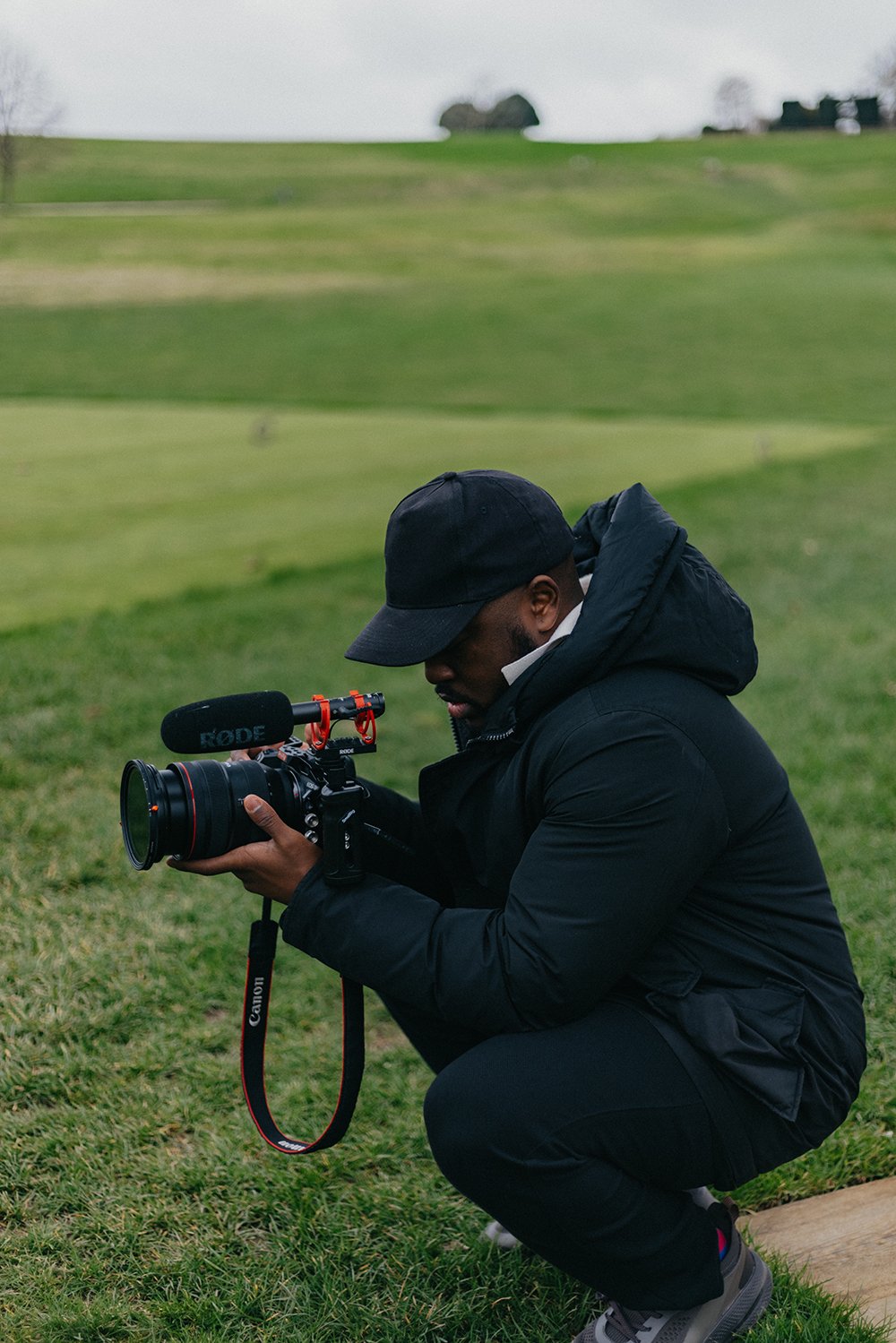 Lionel Odelana filming outdoors with a camera mounted on a stabiliser.